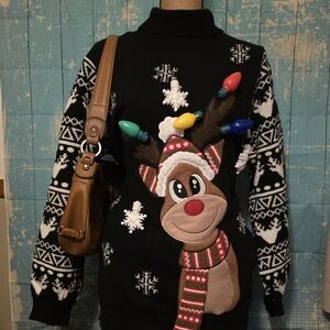 Black‎ and white Christmas reindeer sweater with lights and pockets.